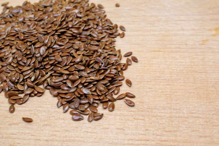linseed grains on a wooden boardの写真素材