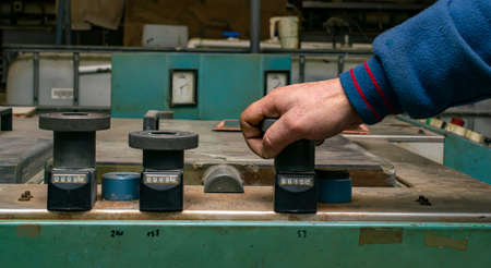 hand on the knob for adjusting the industrial machine