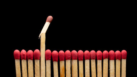 matches in a row on a black background.の写真素材