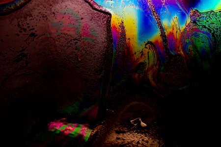 colored stains of gasoline oil on the water, iridescenceの写真素材