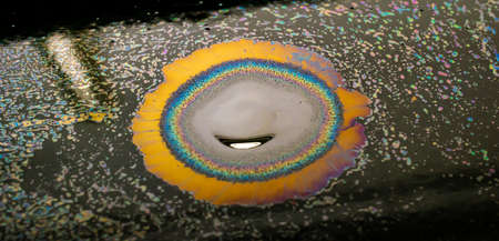 colored stains of gasoline oil on the water, iridescence