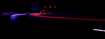 Night road lights. Lights of moving cars at night. long exposure red, blue, green