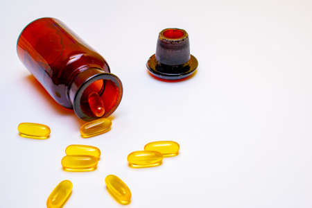 bottle with spilled pills, on a white backgroundの写真素材