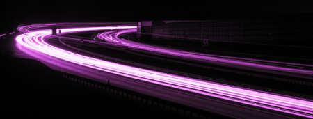 Night road lights. Lights of moving cars at night. long exposure red, blue, green, orange.の写真素材