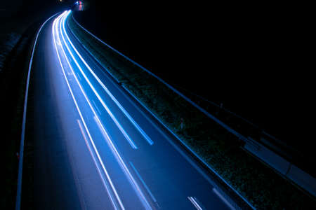 Night road lights. Lights of moving cars at night. long exposure red, blue, green, orange.の写真素材