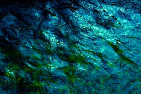 waves on the water surface in dark tonesの写真素材