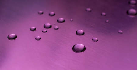 drops of water on a shiny baking sheetの写真素材