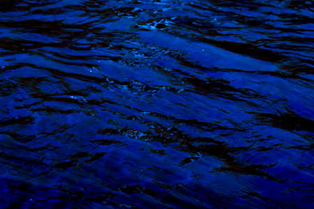 waves on the water surface in dark tonesの写真素材