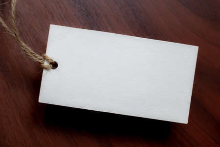 white card with string on black background. place for text.