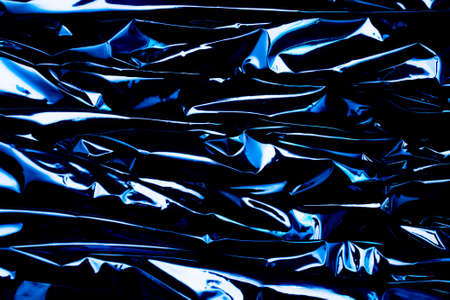 wavy foil, reflections of light, artistic backgroundの写真素材