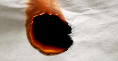 burning edge of paper, glowing edge of paper on black backgroundの写真素材