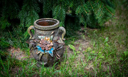 decorative clay pitcher in the garden