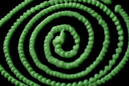 tangle of stream of liquid silicone on a black background