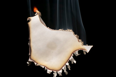 burning paper, glowing edge of paper on a black background