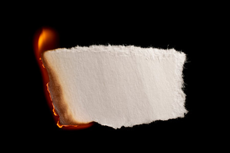 burning paper, glowing edge of paper on a black backgroundの写真素材