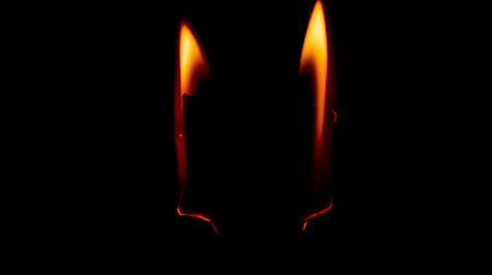 burning paper, glowing edge of paper on a black backgroundの写真素材