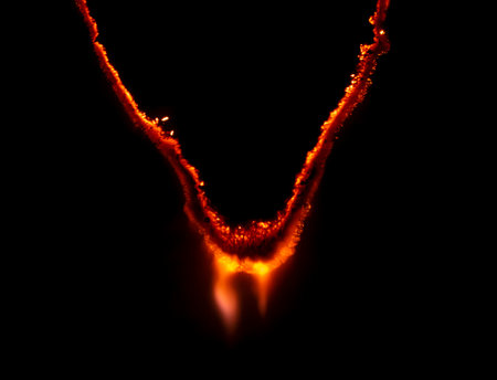 burning paper, glowing edge of paper on a black background
