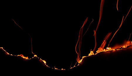 burning paper, glowing edge of paper on a black background