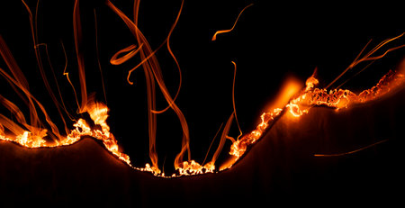 burning paper, glowing edge of paper on a black background