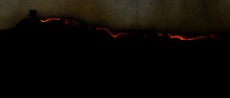 burning paper, glowing edge of paper on a black background