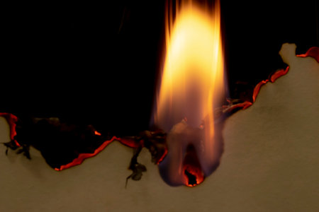 burning paper, glowing edge of paper on a black background
