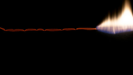 burning paper, glowing edge of paper on a black background