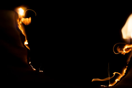 burning paper, glowing edge of paper on a black backgroundの写真素材
