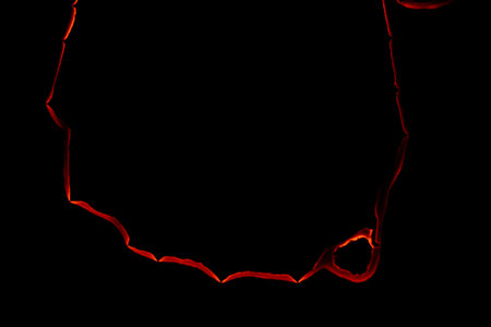 burning paper, glowing edge of paper on a black background