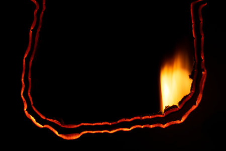 burning paper, glowing edge of paper on a black background