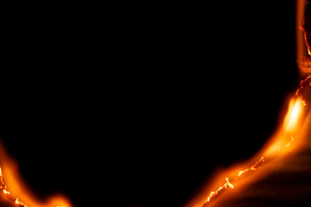 burning paper, glowing edge of paper on a black background