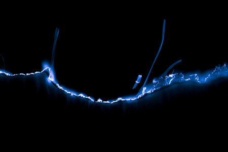 burning paper, glowing edge of paper on a black backgroundの写真素材