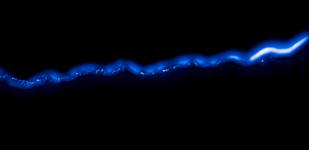 burning paper, glowing edge of paper on a black backgroundの写真素材