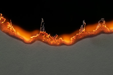 burning paper, glowing edge of paper on a black background