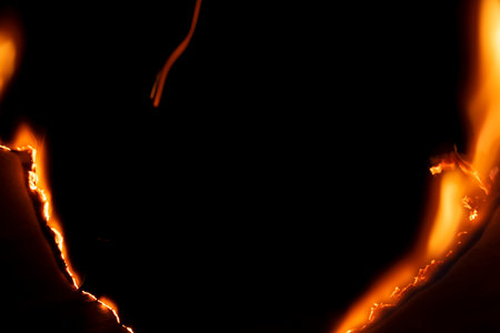 burning paper, glowing edge of paper on a black background