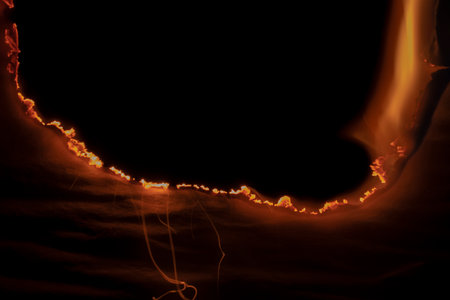 burning paper, glowing edge of paper on a black background