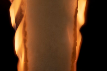 burning paper, glowing edge of paper on a black background