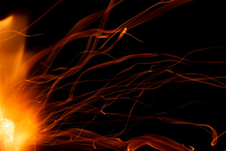 light ribbons of sparks on a black background, long exposureの写真素材
