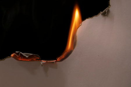 burning paper, glowing edge of paper on a black backgroundの写真素材