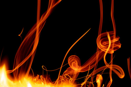 burning paper, glowing edge of paper on a black backgroundの写真素材