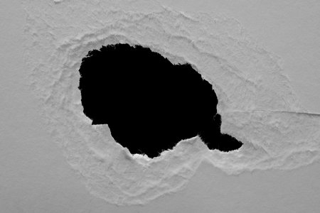 edge of a torn white sheet of paper on a black background, black holeの写真素材