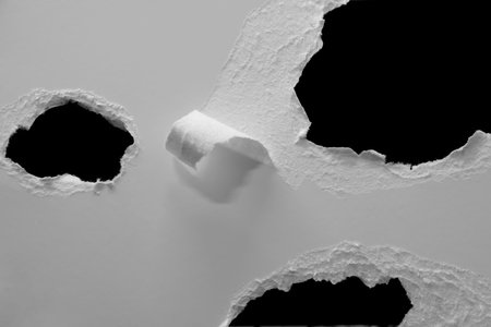 edge of a torn white sheet of paper on a black background, black holeの写真素材
