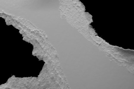 edge of a torn white sheet of paper on a black background, black holeの写真素材