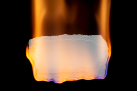burning paper, glowing edge of paper on a black backgroundの写真素材