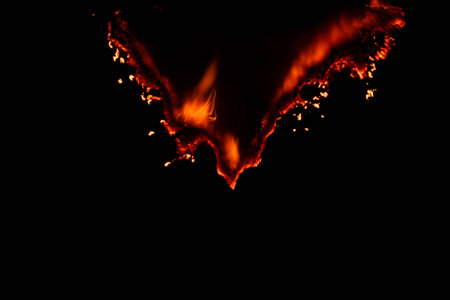 burning paper, glowing edge of paper on a black background