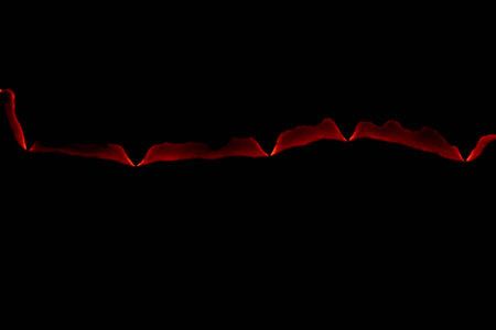 burning paper, glowing edge of paper on a black background