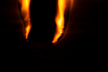 burning paper, glowing edge of paper on a black background