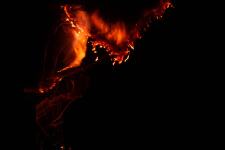 burning paper, glowing edge of paper on a black backgroundの写真素材