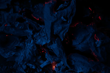 burning paper, glowing edge of paper on a black backgroundの写真素材