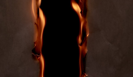 burning paper, glowing edge of paper on a black background