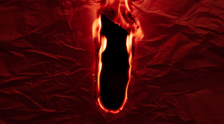 burning paper, glowing edge of paper on a black background